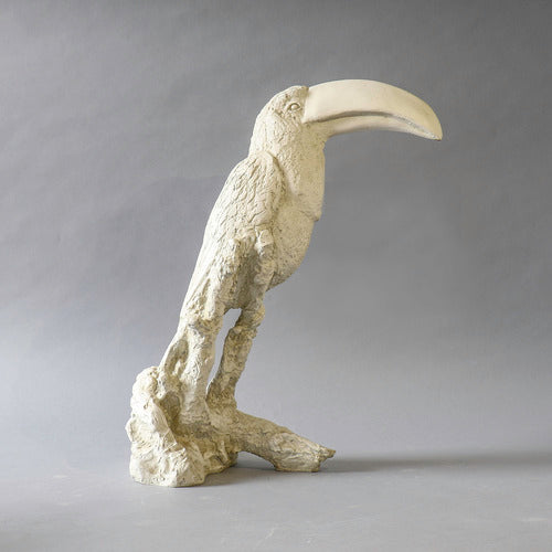 Toucan sculpture with ornate, old world European detailing and classical textured finish, perched on a stylized branch base. Different Angle