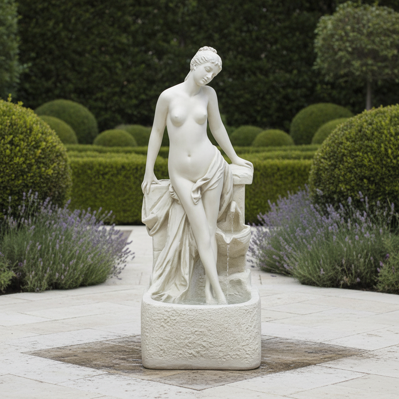 Classical Renaissance-style female statue with draped cloth, standing in a graceful pose on an ornate pedestal. Side Angle