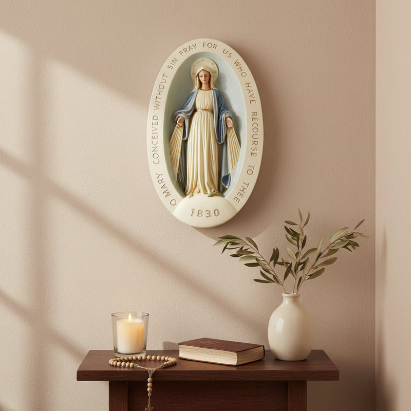 Virgin Mary statue in classical old world European style, set in an ornate oval frame with inscribed prayer and the year 1830. Side Angle
