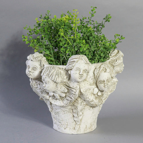 Ornate Baroque-style planter featuring sculpted cherub faces and classical old world European detailing around the rim. Different Angle