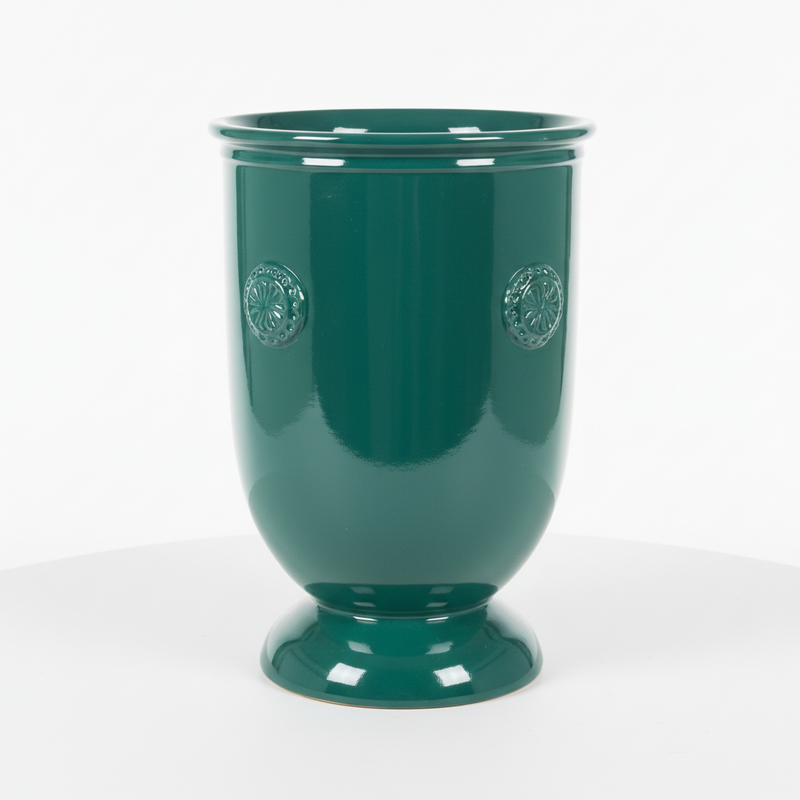 Ornate urn with classical old world European design, featuring embossed medallion details and a flared pedestal base.