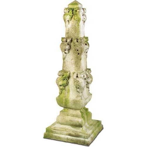 Ornate old world European pedestal with classical lion head motifs and weathered, moss-accented Baroque architectural details.