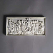 Classical Greek-style relief plaque featuring dancing figures and musicians in an ornate, old world European composition. Different Angle