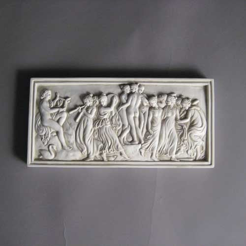 Classical Greek-style relief plaque featuring dancing figures and musicians in an ornate, old world European composition. Different Angle