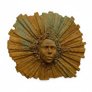 Sunburst wall sculpture with a classical face at the center, radiating ornate, old world European and Renaissance-inspired details.
