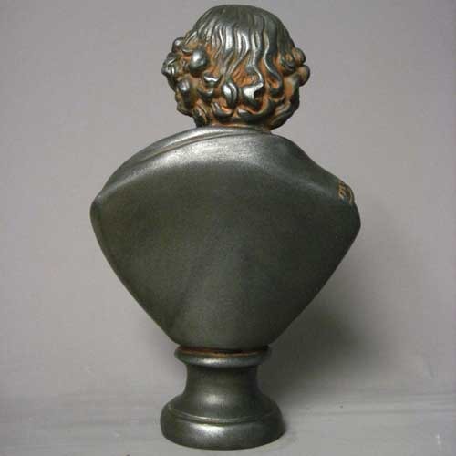 Classical old world European bust of a bearded man in Renaissance attire with ornate detailing and a dignified expression. Side Angle