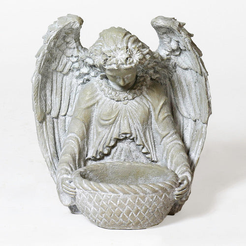 Angel statue with outstretched wings in ornate old world European style, holding a woven bowl with classical detailing.