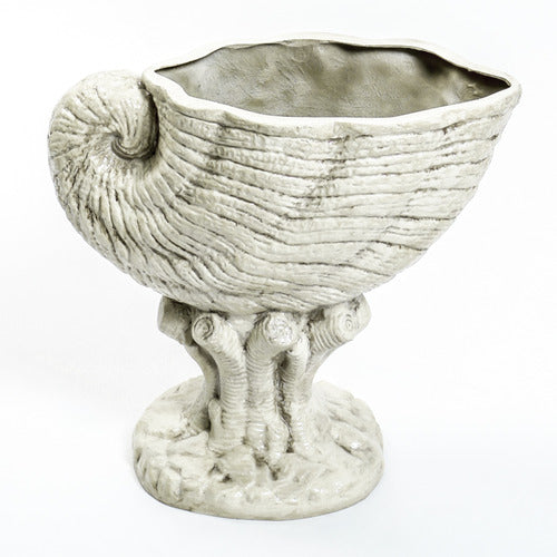 Nautilus shell-shaped vessel with ornate, old world European detailing and classical pedestal base. Side View