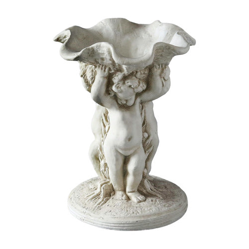 Baroque-style ornate pedestal bowl supported by three cherubs with classical detailing and old world European design elements. Side View