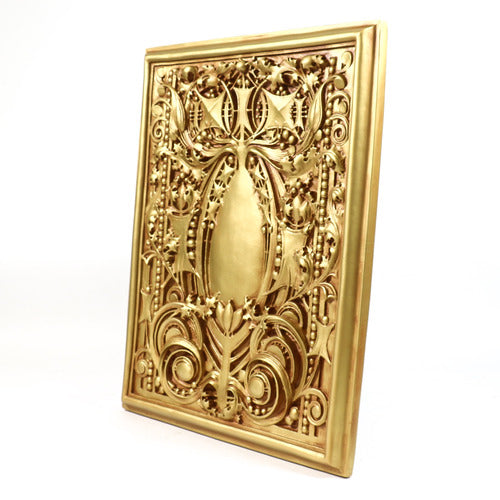 Ornate rectangular plaque with intricate Baroque scrollwork and classical old world European detailing in raised relief. Side View