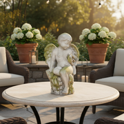 Cherub statue in classical old world European style, seated with wings and ornate detailing, evoking Renaissance garden art. Side Angle