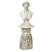 Bust of a distinguished man in classical attire atop an ornate, old world European pedestal with draped rope and tassel details. Side View