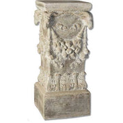 Ornate pedestal with classical old world European design, featuring carved garlands and acanthus leaf motifs in Renaissance style.