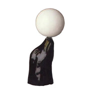 Sculpted black horse head in classical style balancing a smooth, round orb atop its nose, evoking old world European elegance.