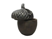 Acorn-shaped container with ornate, old world European style lid featuring detailed leaf and textured pattern Side View