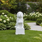 St. Bernard dog statue with barrel collar, seated on a pedestal in classical European style with subtle ornate detailing. Side Angle