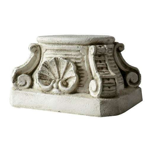 Ornate pedestal base with classical scrollwork, shell motif, and old world European architectural detailing in a Baroque style.
