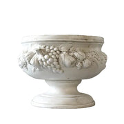 Ornate classical pedestal bowl with Baroque fruit and floral relief, featuring old world European decorative detailing.