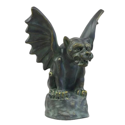 Gothic gargoyle statue with outstretched wings, fierce expression, and ornate old world European detailing on a pedestal base.