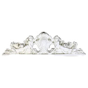 Ornate Baroque-style architectural pediment with two cherubs, intricate scrollwork, and classical old world European detailing. Side View