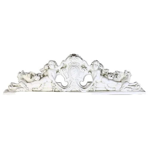 Ornate Baroque-style architectural pediment with two cherubs, intricate scrollwork, and classical old world European detailing. Side View
