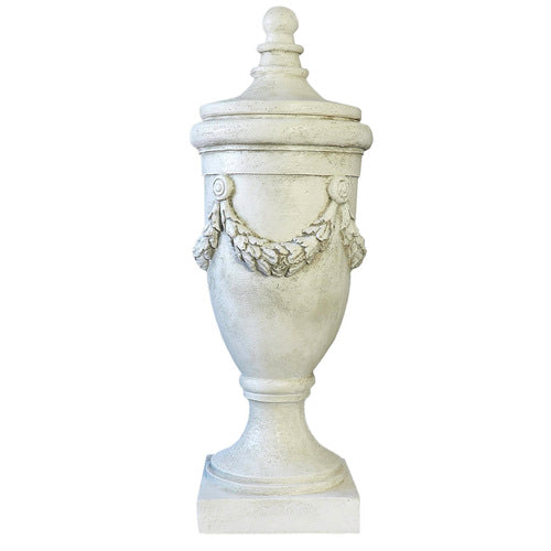 Ornate classical urn with garland relief and pedestal base, featuring a detached finial lid, in old world European style. Side Angle