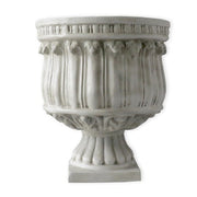 Ornate classical urn planter with fluted body, decorative relief details, and pedestal base in old world European style. Side Angle