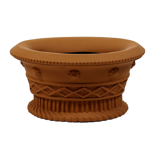 Ornate planter with classical old world European detailing, featuring shell motifs, lattice patterns, and a fluted base. Side Angle