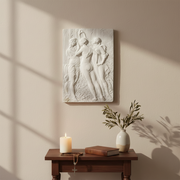 Classical bas-relief panel depicting three women in flowing robes, inspired by Renaissance and old world European artistry. Side Angle