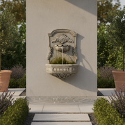 Ornate old world European wall fountain with classical lion head spout, Baroque scrollwork, and decorative architectural details Side Angle