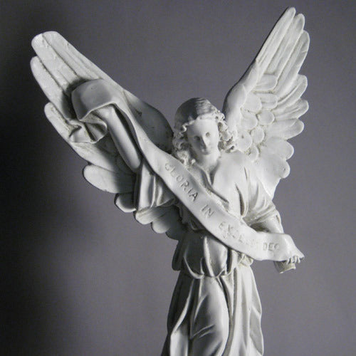 Baroque-style angel with flowing robes and outstretched wings holding a scroll inscribed with "Gloria in Excelsis Deo" Other Angle