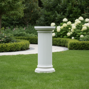 Classical Greek fluted column pedestal with ornate base and capital, featuring old world European architectural style. Side Angle