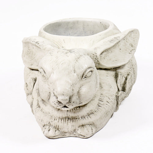 Rabbit-shaped planter with ornate floral motif, featuring old world European style and filled with yellow and orange flowers. Different Angle