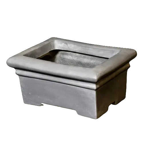 Rectangular planter with wide rim and stepped base, featuring classical old world European architectural lines and understated ornate detailing. Side View