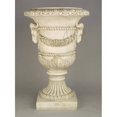 Ornate classical urn with ram head accents, laurel garland, and fluted pedestal in old world European Baroque style. Different Angle