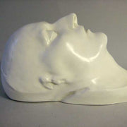 Classical European sculpted head with closed eyes, smooth features, and serene expression, evoking Renaissance and old world style. Other Angle