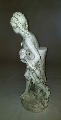 Classical European statue of a woman with two children, featuring ornate, old world detailing and Renaissance-inspired drapery. Different Angle