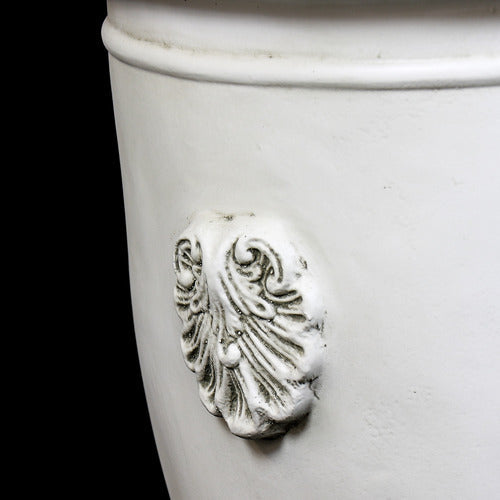 Classical urn planter with ornate Baroque shell motifs and a pedestal base, featuring old world European design elements. Side Angle