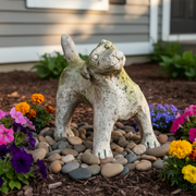 Playful dog statue with raised tail, featuring weathered, old world European style and subtle ornate detailing. Side Angle