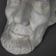 Classical old world European sculpted head with closed eyes, detailed facial features, and a prominent beard in Renaissance style. Different Angle