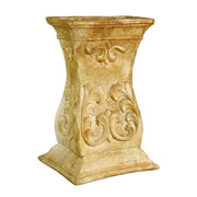 Ornate pedestal with classical old world European scrollwork and Baroque-inspired decorative carvings on a flared square base.