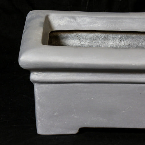Rectangular planter with wide rim and stepped base, featuring classical old world European architectural lines and understated ornate detailing. Side Angle