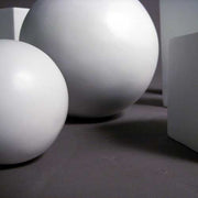 Geometric forms arranged in a group, featuring spheres, cubes, cones, pyramids, and cylinders in a classical study composition. Side Angle