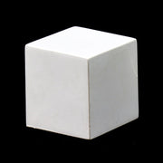 White geometric cube with smooth, clean edges and minimalist, classical design set against a solid black background.
