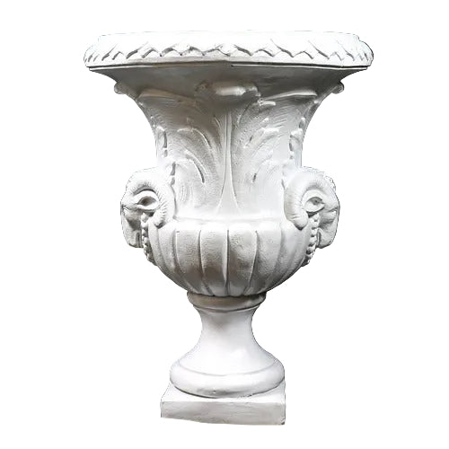 Ornate classical urn with Baroque detailing, acanthus leaf motifs, and ram head accents on a pedestal base. Side View