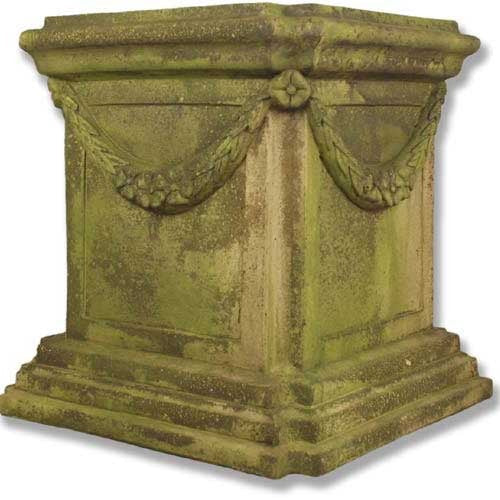 Ornate square pedestal with classical old world European design, featuring garland relief and weathered, mossy Baroque detailing.