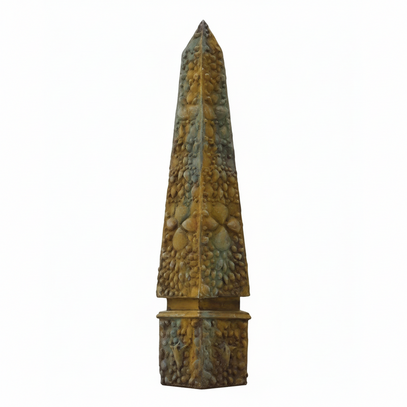 Obelisk sculpture with ornate, old world European detailing and textured Baroque-inspired surface, featuring classical geometric form. Side View