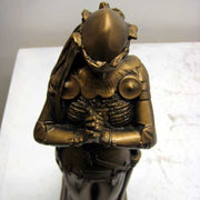Kneeling medieval knight in ornate armor, hands clasped in prayer, classical old world European style with Gothic detailing. Side Angle View