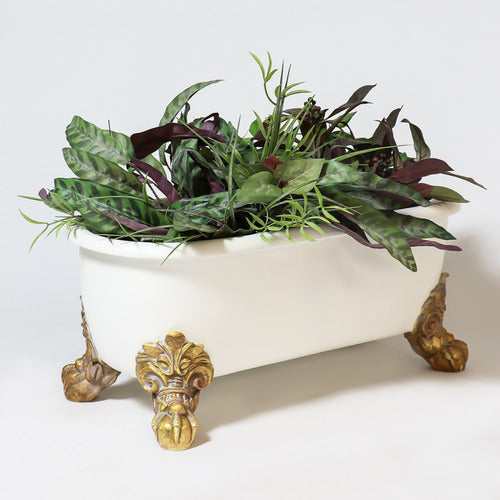 Clawfoot bathtub with ornate, Baroque-style gold feet and classical old world European design. Side Angle