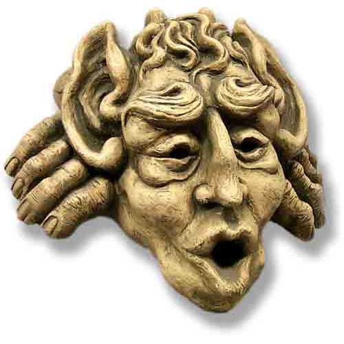 Grotesque face sculpture with exaggerated features and curled horns, medieval Gothic style with ornate, expressive detailing.